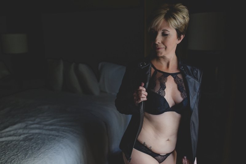 Black lacy bra and undies with a black moto jacket on a women in her fifties for a session by St Pete boudoir photographer - Tami Keehn