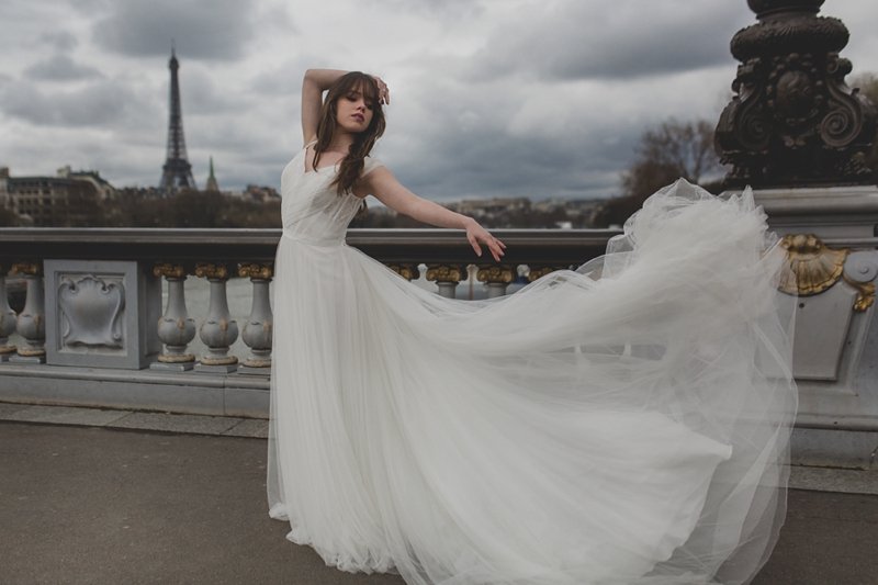 Beautiful ballerina bride in Paris with the Eiffel tower behind her being photographed by Tami Keehn