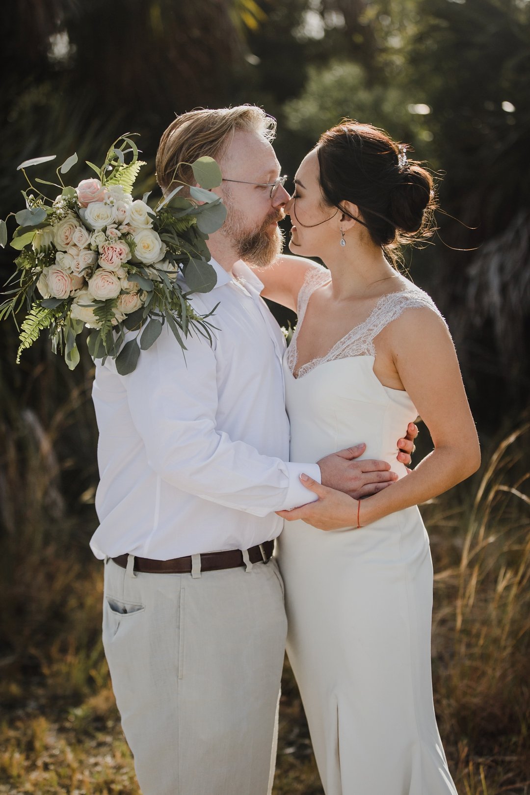A beautiful couple celebrates their intimate elopement on Honeymoon Island with Saint Petersburg Florida wedding photographer Tami Keehn. 