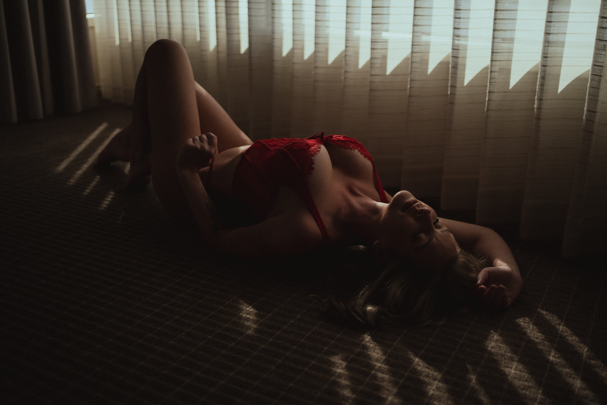 Lady in Red poses for a boudoir shoot for luxury Tampa boudoir photographer Tami Keehn